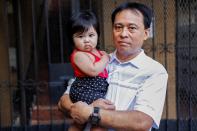 Jose Ramirez poses with his daughter Mary Amber outside their home in Honolulu