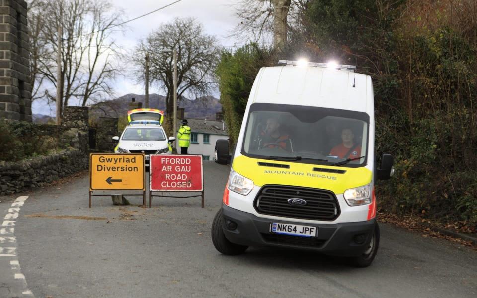 A police road block in Garreg Ilanfrothen on the A4085, approximately 3/4 of a mile from the crash scene