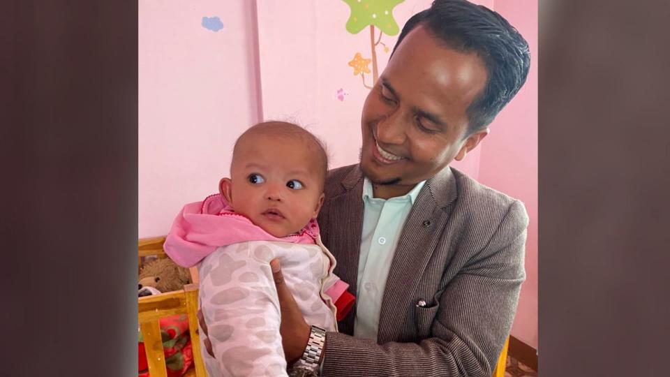 Kyrmen Shylla with baby Wanhi at the adoption agency.