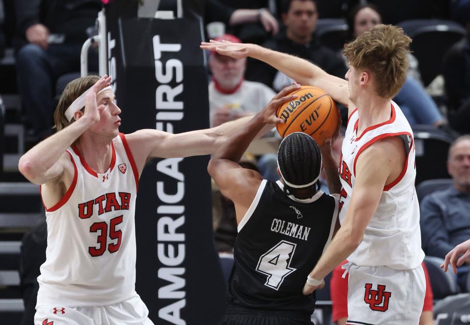 Utah Utes center Branden Carlson (35) and Utah Utes guard Cole Bajema (2) defend Hawaii Warriors guard Noel Coleman (4) at the Delta Center in Salt Lake City on Thursday, Nov. 30, 2023. | Jeffrey D. Allred, Deseret News