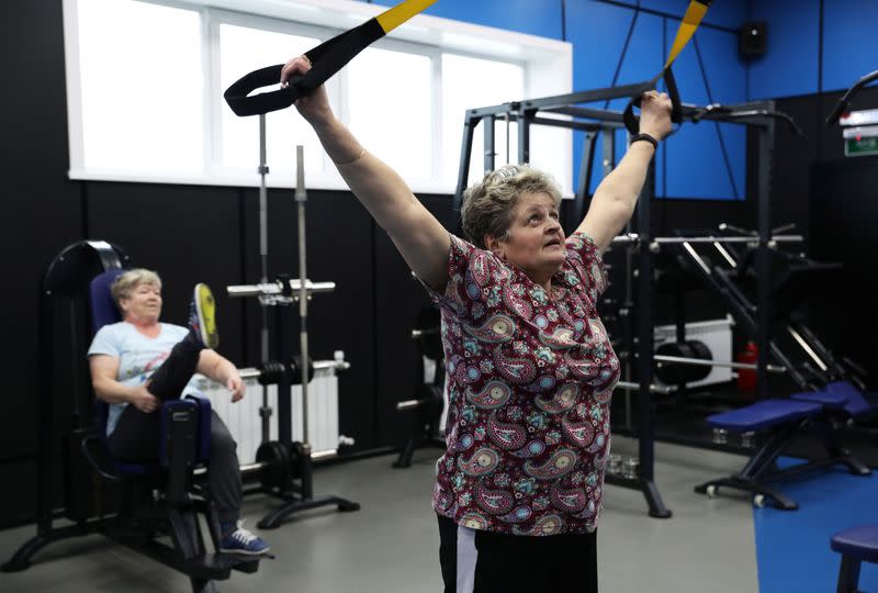 Members of a senior women's hockey team "Ustyanochka" exercise at a gym in Bereznik