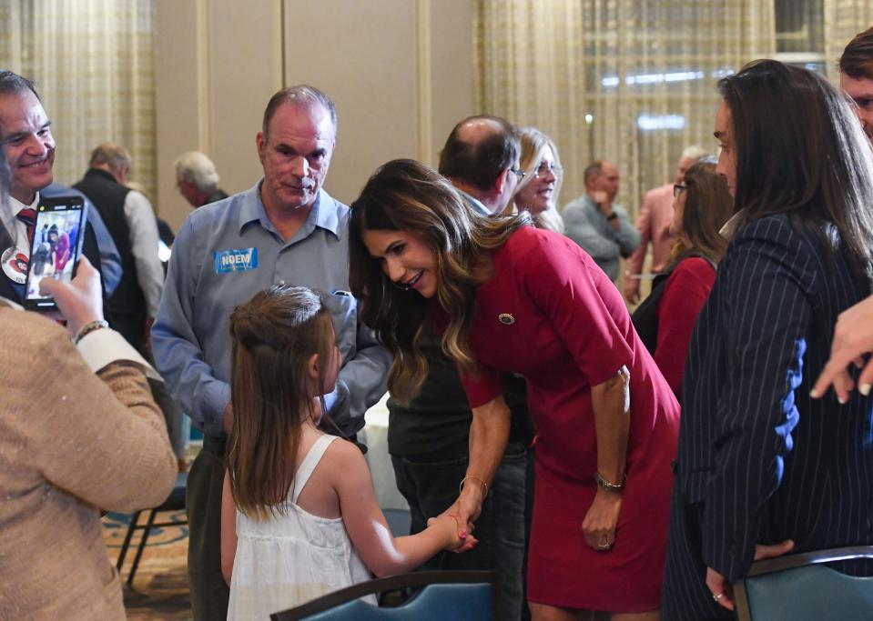 Governor Kristi Noem shakes hands with 8-year-old Doris Trippett during an election night watch party on Tuesday, June 7, 2022, at the Hilton Garden Inn in Sioux Falls.