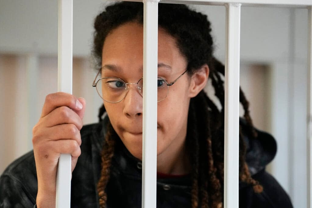 WNBA star and two-time Olympic gold medalist Brittney Griner stands in a cage at a court room prior to a hearing, in Khimki just outside Moscow, Russia, Tuesday, July 26, 2022. (AP Photo/Alexander Zemlianichenko, Pool)