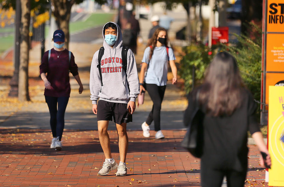 BU students walk down Commonwealth Ave. outside the George Sherman Union (GSU) at Boston University in Boston on Oct. 22, 2020. (John Tlumacki/The Boston Globe via Getty Images)