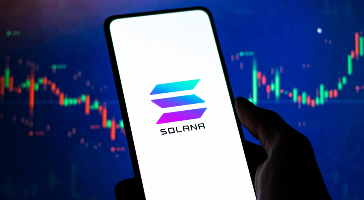 Solana logo on phone screen stock image. Solana price predictions.