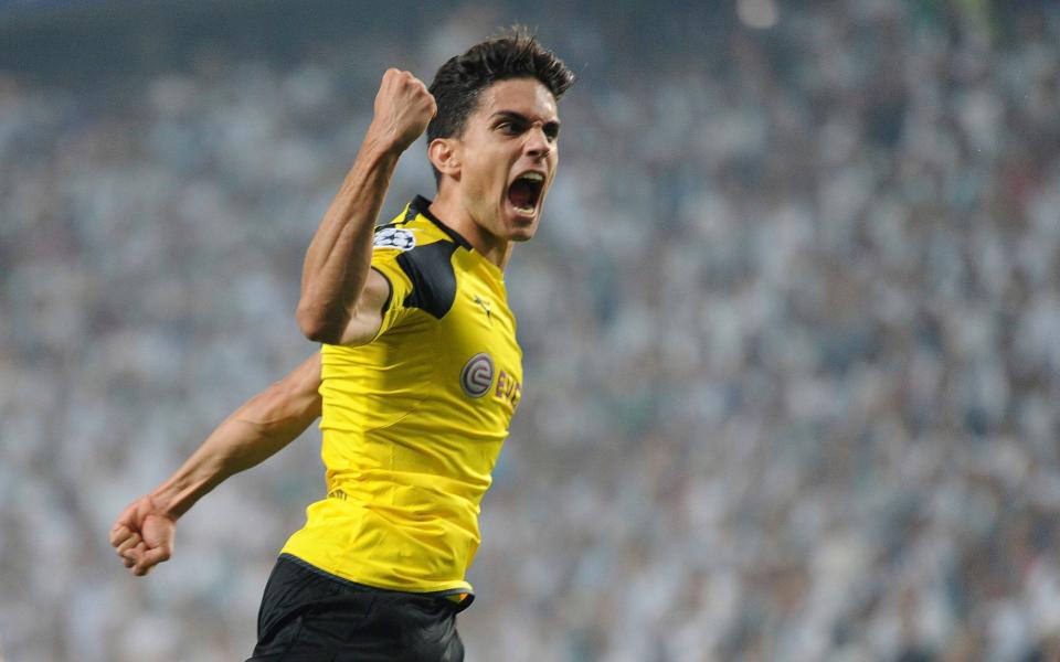 In this file photo dated Wednesday, Sept. 14, 2016, Dortmund's Marc Bartra celebrates after scoring during the Champions League Group F soccer match between Legia Warsaw and Dortmund - Credit: AP