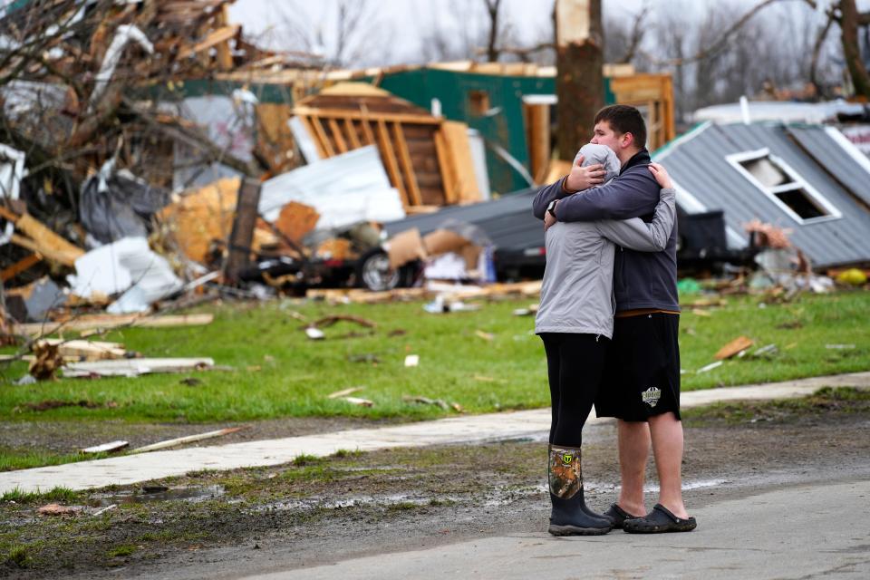 A young couple, who had just moved into their rehabbed home last year in Lakeview, Ohio, is overcome Friday, March 15, 2024, as they survey the damage from the tornado that swept through their neighborhood the previous night.