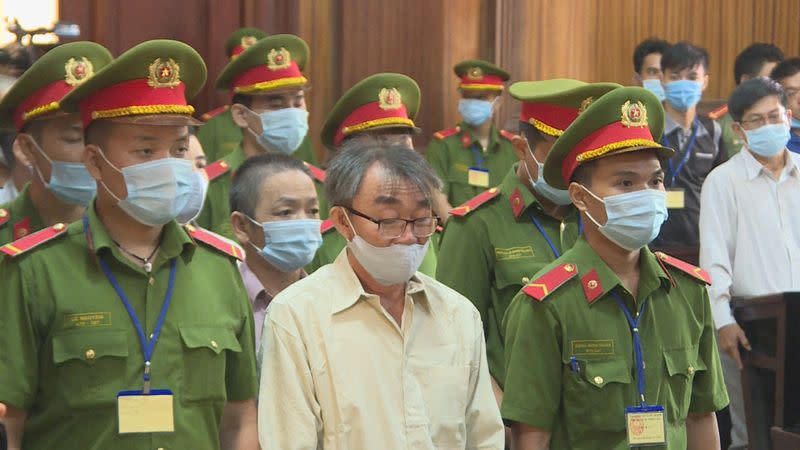 Defendants of Trieu Dai Viet group stand during their trial at a court in Ho Chi Minh City