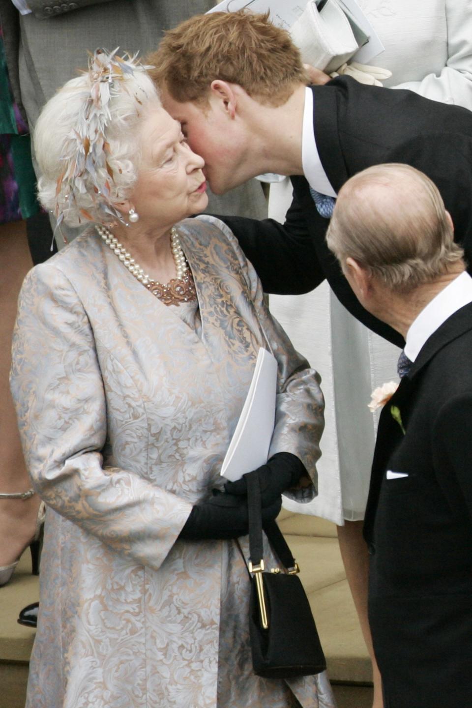 Harry gives his grandmother a kiss on the cheek following the wedding of cousin Peter Phillips to Autumn Kelly at St. George's Chapel in 2008. 