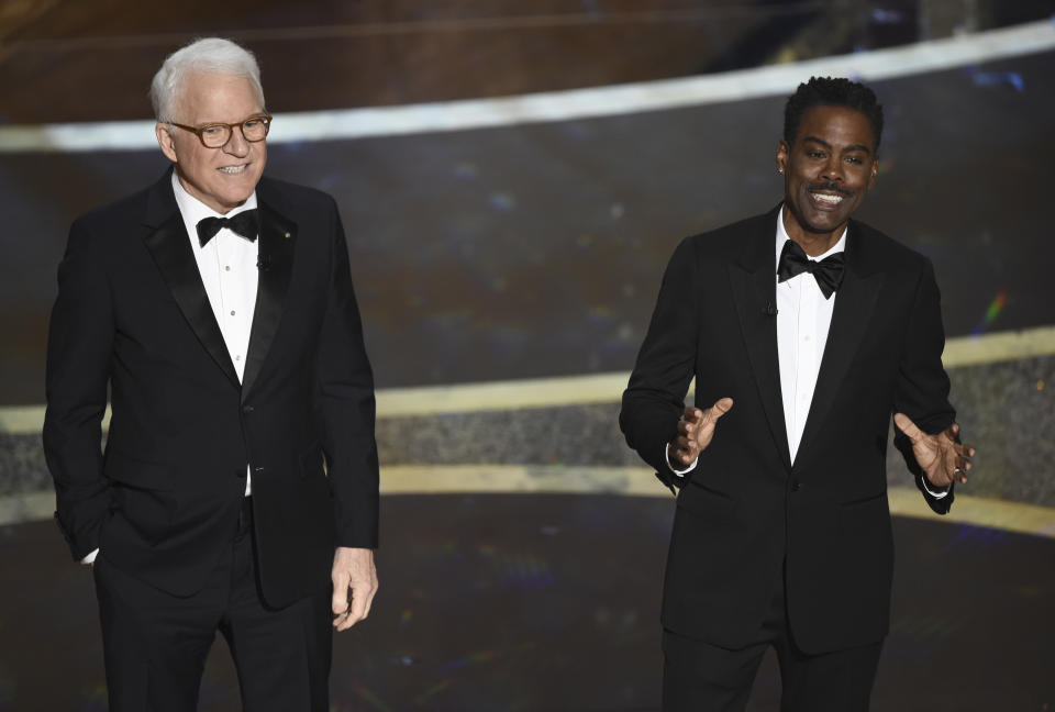 Steve Martin, left, and Chris Rock speak at the Oscars on Sunday, Feb. 9, 2020, at the Dolby Theatre in Los Angeles. (AP Photo/Chris Pizzello)