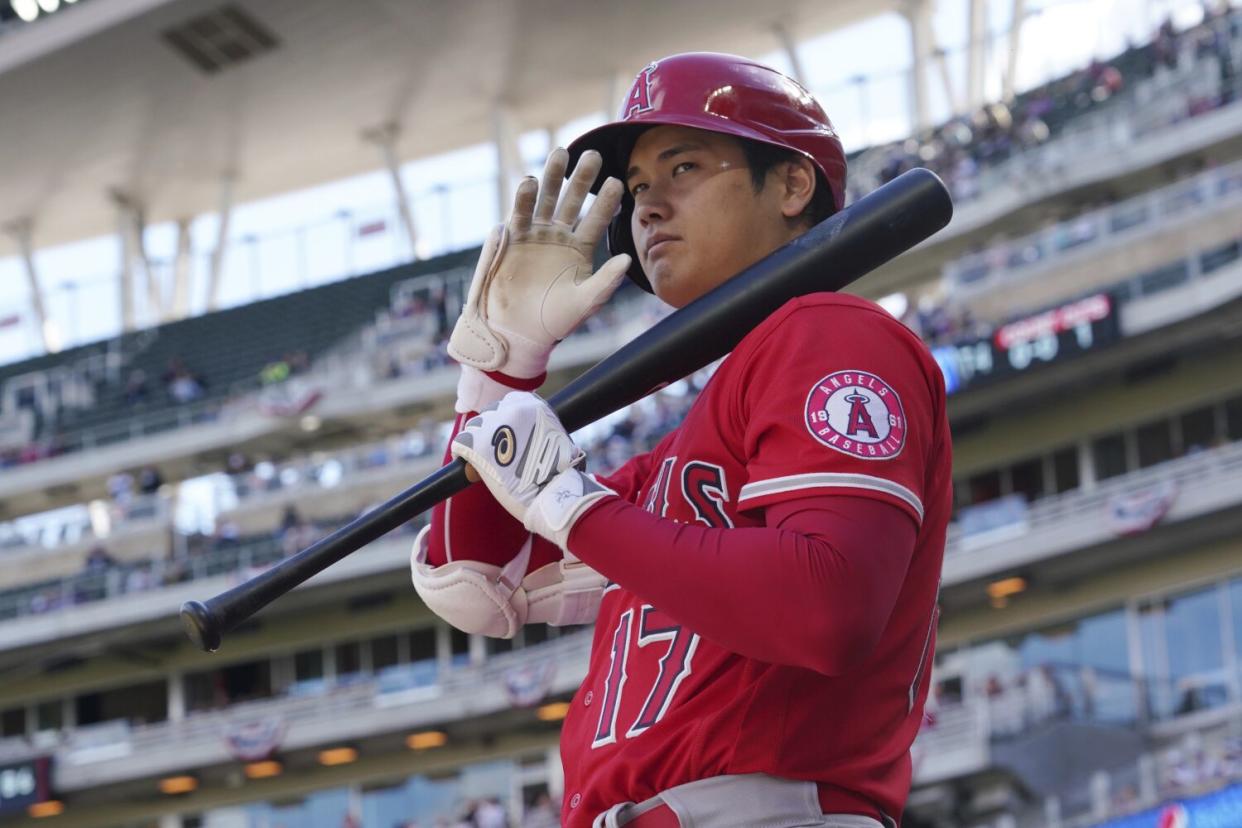 Los Angeles Angels' pitcher Shohei Ohtani (17) waves to fans as he waits on deck to bat in the fourth inning.