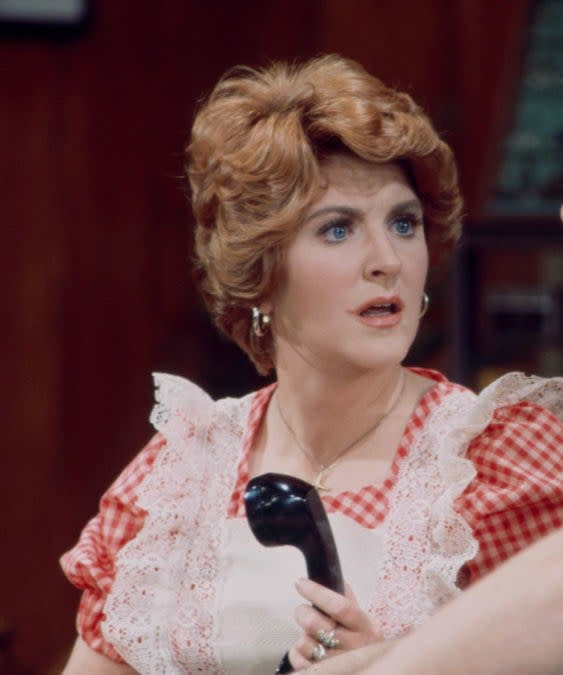 Fannie Flagg with her mouth open in shock and a telephone in her hand