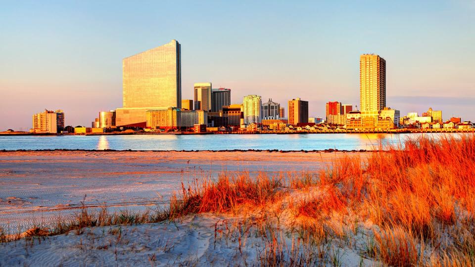 Atlantic City skyline hotel casinos from a scenic beach.