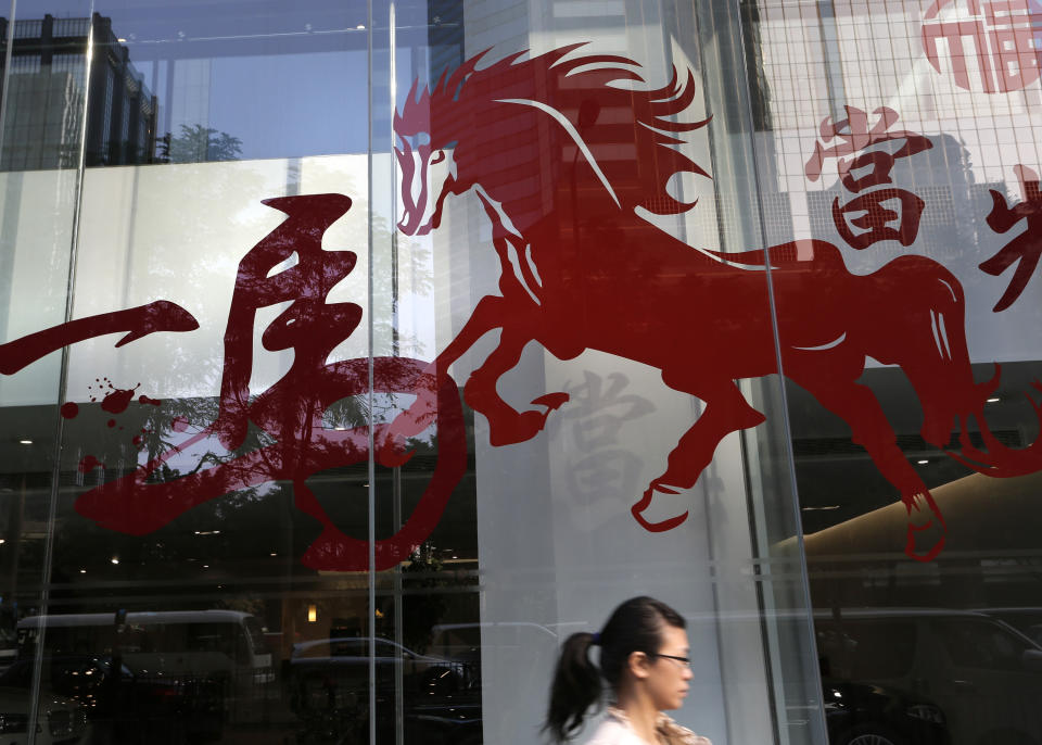 In this Monday, Jan. 27, 2014 photo, a horse decoration for the Chinese Lunar New Year is displayed on the wall of a building in Hong Kong. Chinese communities around the world were welcoming the arrival of the year of the horse on Friday, Jan. 31 with equine-themed decorations and celebrations. The annual Lunar New Year holiday is mark with particular verve in Hong Kong, the semi-autonomous Chinese financial center that expects 7.93 million visitors, more than territory’s permanent population of 7.1 million. (AP Photo/Vincent Yu)