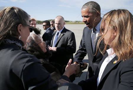 Author and founding member of the Fairbanks Native Association Poldine Carlo (L) greets U.S. President Barack Obama after he arrived aboard Air Force One at Elmendorf Air Force Base in Anchorage, Alaska August 31, 2015. REUTERS/Jonathan Ernst