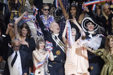 French designer Jean Paul Gaultier (C) reacts as he appears at the end of his Spring/Summer 2015 women's ready-to-wear collection during Paris Fashion Week September 27, 2014. REUTERS/Gonzalo Fuentes