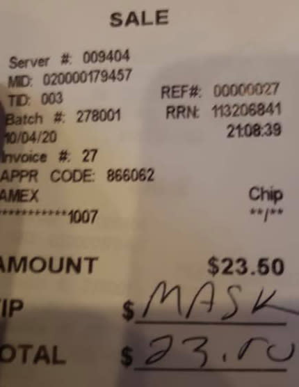 A receipt from a restaurant with 'mask' written in the tip section.