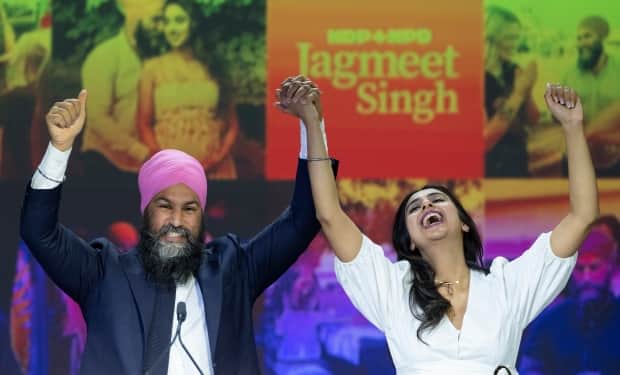 NDP Leader Jagmeet Singh and his wife, Gurkiran Kaur Sidhu, arrive on stage Monday to address supporters at his election night headquarters in Vancouver during the 2021 Canadian federal election. (Jonathan Hayward/Canadian Press - image credit)