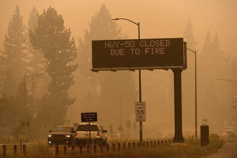 FILE - In this Friday, Aug. 27, 2021 file photo, a sign in Eldorado County, Calif., warns motorists about the closure of Highway 50, which is shut down in both directions due to the Caldor Fire. Last week, managers overseeing the fight against the massive wildfire scorching California's Lake Tahoe region thought they could have it contained by the start of this week. Instead, on Monday, Aug. 30, 2021, the Caldor Fire crested the Sierra Nevada, forcing the unprecedented evacuation of all 22,000 residents of South Lake Tahoe. (AP Photo/Noah Berger)