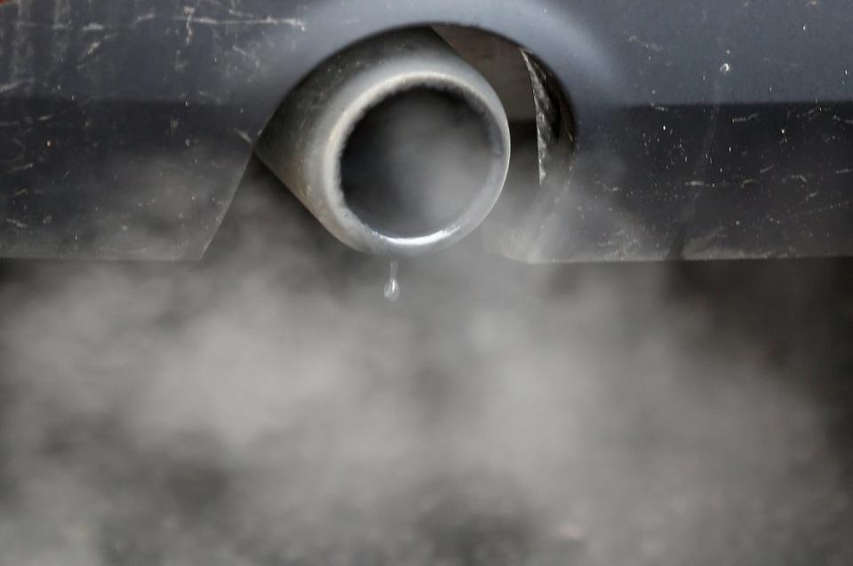 FILE PHOTO: An exhaust emits fumes as a car is driven through Richmond in London, Britain December 2, 2016.  