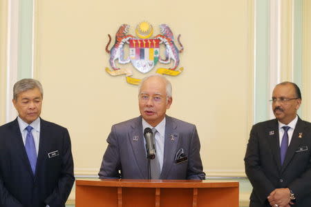 Malaysia's Prime Minister Najib Razak (C) announces the appointment of new Deputy Prime Minster Ahmad Zahid Hamidi (L) beside Malaysia's Chief Secretary to the Government Ali Hamsa (R) following a cabinet reshuffle in Putrajaya, Malaysia, July 28, 2015. REUTERS/The New Straits Times Press/Mohd Fadli Hamzah