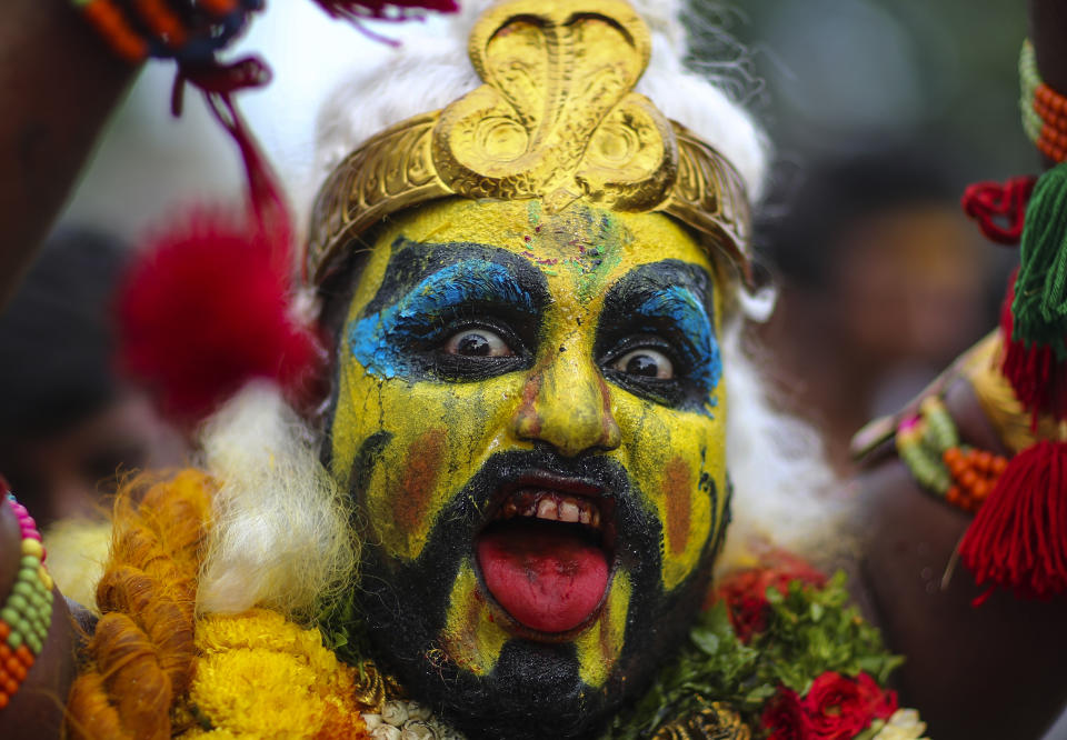 A devotee of Hindu goddess Kali performs a ritual during the 'Bonalu' festival at the Golconda Fort in Hyderabad, India, Sunday, July 11, 2021. Bonalu is a month-long Hindu folk festival of the Telangana region dedicated to Kali, the Hindu goddess of destruction. (AP Photo/Mahesh Kumar A.)