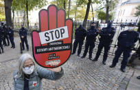 Pro-choice activists from "Women Strike" attend a protest in front of Poland's constitutional court, in Warsaw, Poland, Thursday, Oct. 22, 2020. Poland’s top court has ruled that a law allowing abortion of fetuses with congenital defects is unconstitutional. The decision by the country’s Constitutional Court effectively bans terminating pregnancies in cases where birth defects are found and will further limit access to abortions in Poland. Sign reads "stop tightening the law" (AP Photo/Czarek Sokolowski)