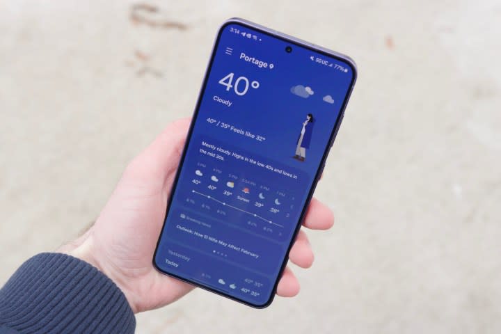 Someone holding the Samsung Galaxy S24 Plus, showing the weather app.