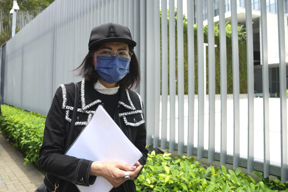 Mrs. Poon, the mother of a young woman killed in Taiwan, speaks to the media outside the government headquarters in Hong Kong, Wednesday, Oct. 20, 2021. Mrs. Poon, whose daughter Poon Hiu-wing was killed while visiting Taiwan in 2018, has lambasted Hong Kong authorities for letting suspect Chan Tong-kai walk free, instead of sending him to Taiwan to turn himself in. (AP Photo/Kin Cheung)