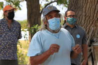 This Aug. 31, 2021 photo shows Don Bustos, owner of Santa Cruz Farm in Espanola, New Mexico, talking about changes he has made to conserve water. Bustos and other farmers who relying on traditional irrigation systems say they are seeing less water in their systems as a result of less winter snowpack in the mountains and warmer temperatures. (AP Photo/Susan Montoya Bryan)