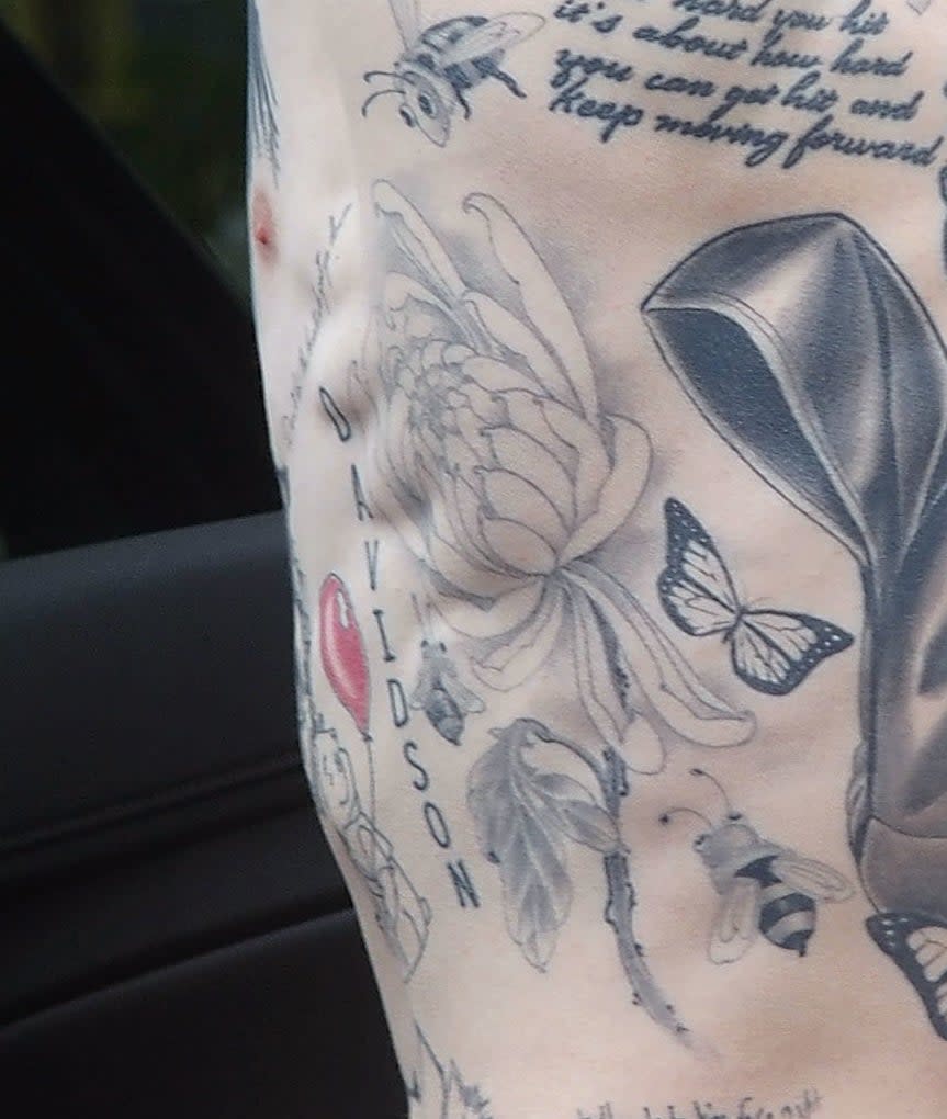 A closeup of the tattoos described