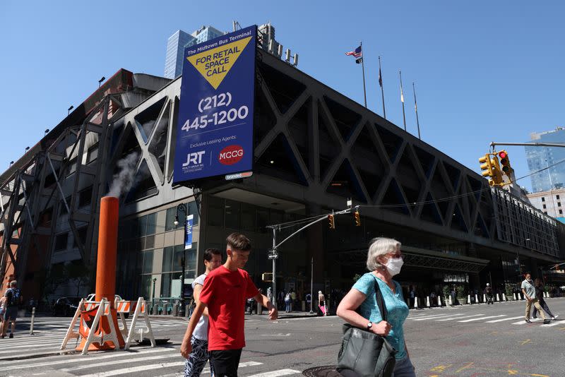 People walk by the Port Authority Bus Terminal where earlier migrants arrived from Texas under the order of Governor Greg Abbott in Manhattan, New York City