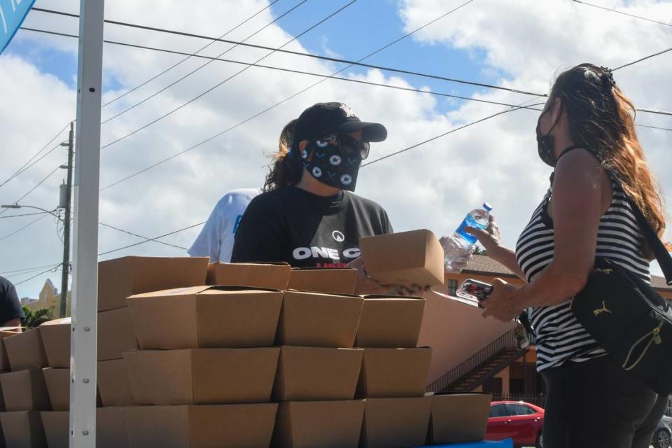 Miami Marlins Foundation executive director Raquel “Rocky” Egusquiza hands out a meal at the Citrus Grove Middle School polling location in Little Havana, Florida, on Tuesday, Nov. 3, 2020. The Miami Marlins Foundation in partnership with Feed The Polls gave away 4,000 meals at two polling locations on Election Day.