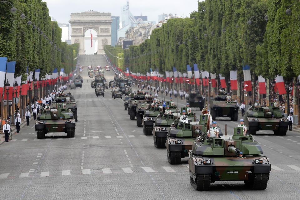 <p>Tanks drive down the Champs Elysees avenue during the Bastille Day parade in Paris, Friday, July 14, 2017. (Photo: Markus Schreiber/AP) </p>