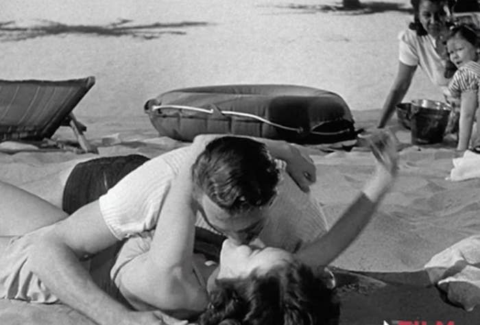 two people kissing on the beach