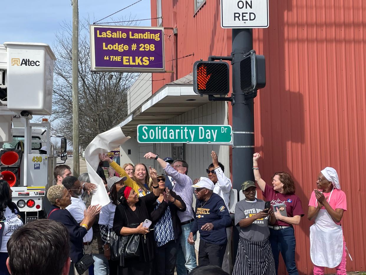 Democratic candidates gather outside the LaSalle Landing Lodge No. 298 to unveil a temporary street sign in honor of Solidarity Day.