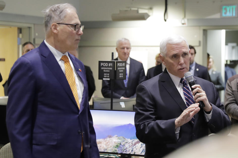 Vice President Mike Pence, right, speaks with Gov. Jay Inslee at the Washington State Emergency Operations Center, Thursday, March 5, 2020 at Camp Murray in Washington state. Pence was visiting to discuss Washington state's efforts to fight the COVID-19 coronavirus. (AP Photo/Ted S. Warren)