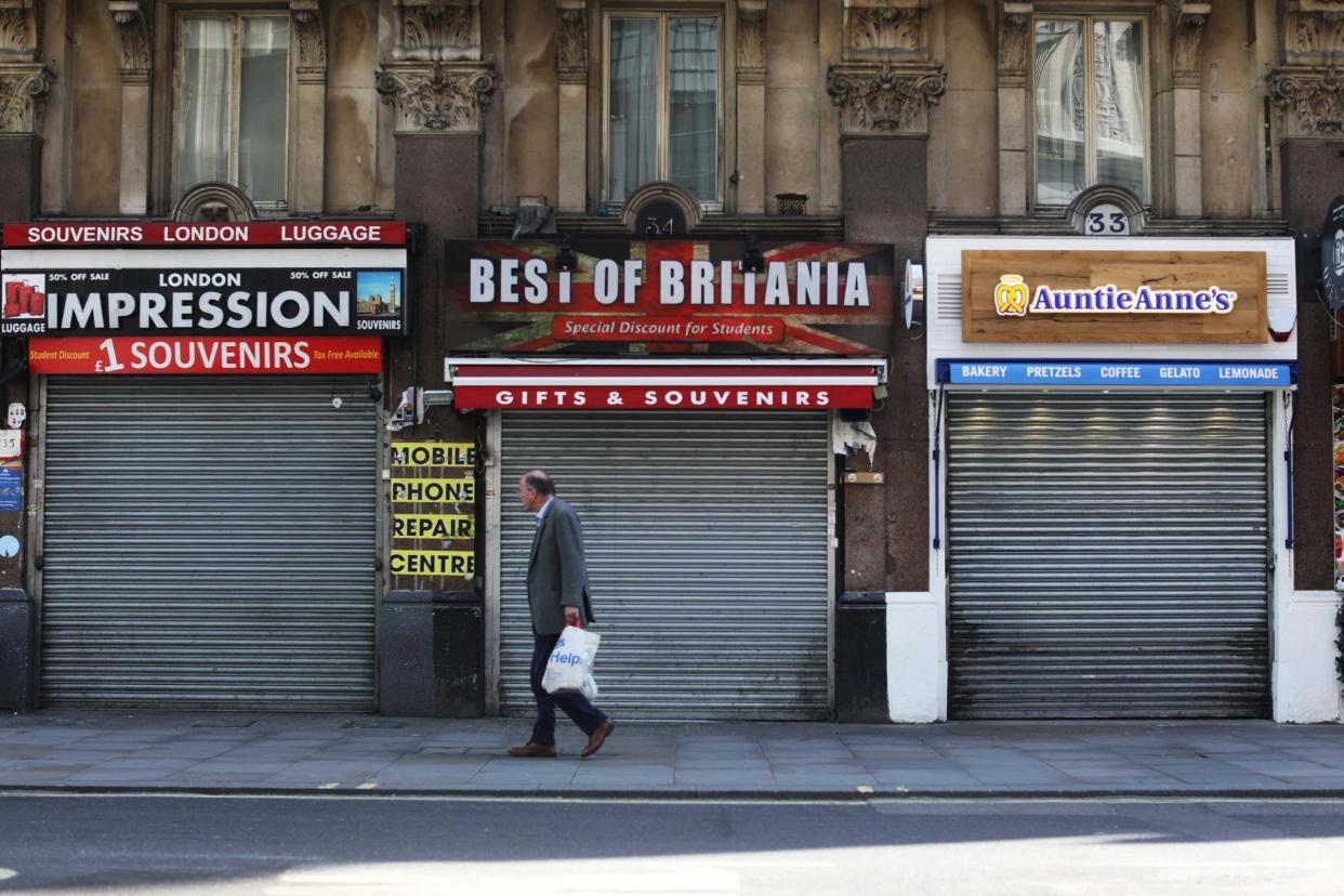 A man is seen passing a closed souvenir shop, following the outbreak of the coronavirus disease (COVID-19), London, Britain, May 7, 2020: Reuters