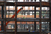 Workers move materials around as construction resumed on the New York Islanders' new arena, located adjacent to Belmont race track Wednesday, May 27, 2020, in Elmont, New York. Long Island became the latest region of New York to begin easing restrictions put in place to curb the spread of the coronavirus as it enters the first phase of the state's four-step reopening process. Construction, manufacturing, agriculture and retail with curbside pickup are permitted in the first phase of reopening.(AP Photo/Kathy Willens)