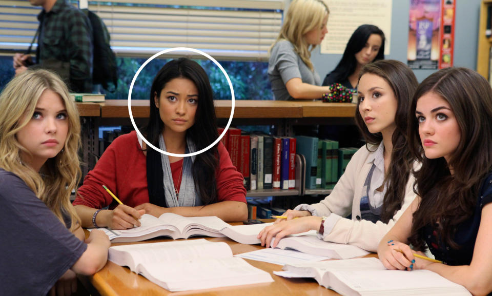 Ashley Benson, Shay Mitchell, Troian Bellisario and Lucy Hale from "Pretty Little Liars" sitting at a library table with books open, looking serious