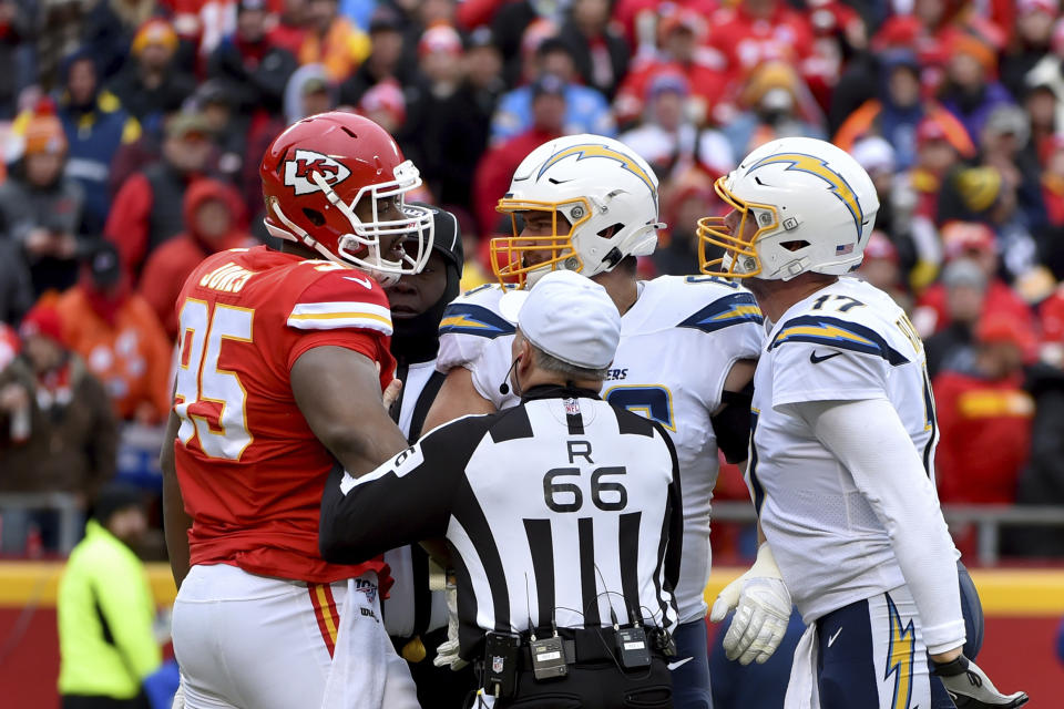 Kansas City Chiefs defensive tackle Chris Jones (95) and Los Angeles Chargers quarterback Philip Rivers (17) argue during the first half of an NFL football game in Kansas City, Mo., Sunday, Dec. 29, 2019. (AP Photo/Ed Zurga)