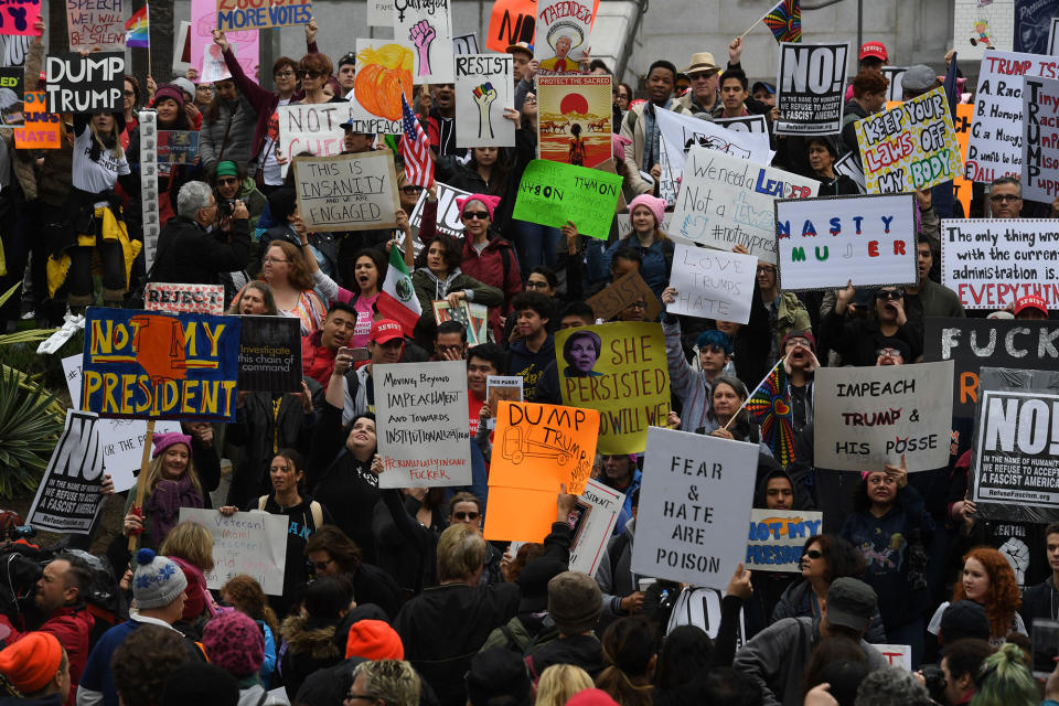 <p>Protesters carry anti-Trump signs during a ‘Not My President Day’ demonstration outside City Hall in Los Angeles, California, on February 20, 2017. (Mark Ralston/AFP/Getty Images) </p>