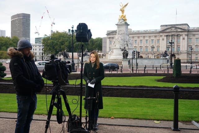 A TV news crew outside Buckingham Palace after the Queen returned to Windsor Castle 