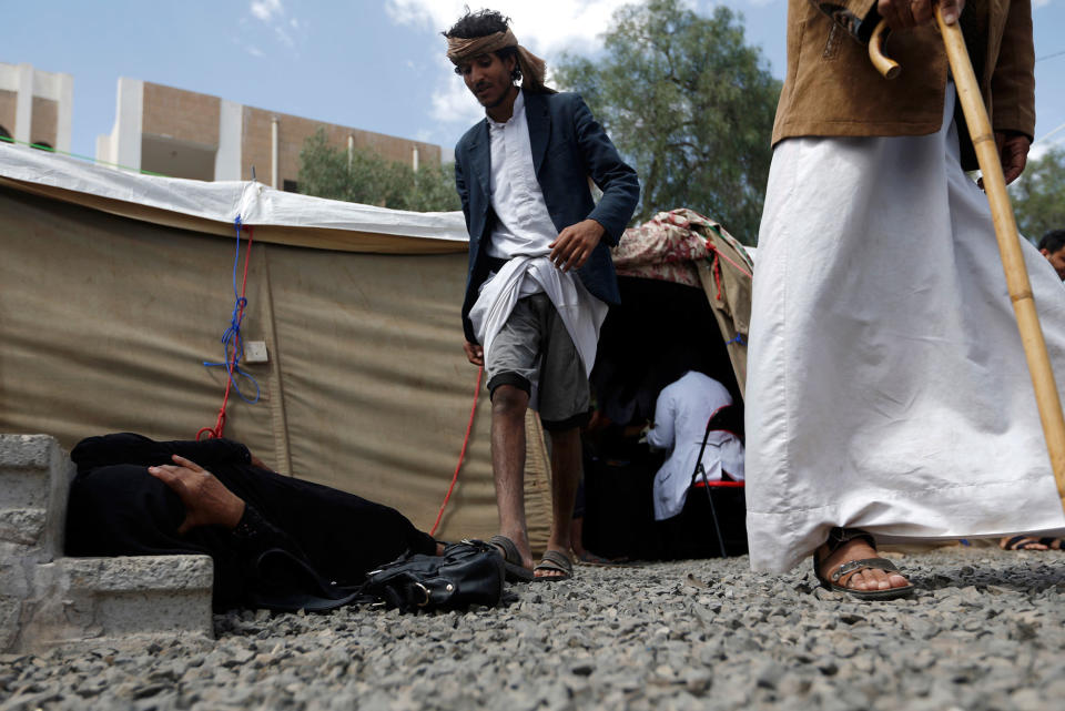 <p>A Yemeni woman suspected of being infected with cholera lies on the ground at Sabaeen Hospital in Sana’a on June 13, 2017.<br> Six weeks into the second outbreak of the deadly disease in less than a year, at least one patient checks in at Sabaeen every 60 seconds — a level of emergency that overwhelms staff. (Mohammed Huwais/AFP/Getty Images) </p>