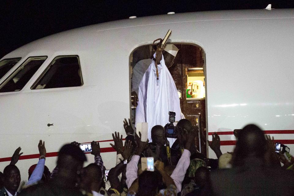 FILE - Gambia's defeated leader Yahya Jammeh waves to supporters as he departs from Banjul airport on Jan. 21, 2017, as he has decided to relinquish power. Switzerland’s top criminal court has convicted Ousman Sonko, a former interior minister of Gambia, for crimes against humanity during repression by the west African country’s security forces against opponents under then-President Yahya Jammeh. The Swiss attorney general’s office said the indictment against Sonko, filed a year ago, covered alleged crimes during 16 years under Jammeh, whose rule was marked by arbitrary detention, sexual abuse and extrajudicial killings. (AP Photo/Jerome Delay)