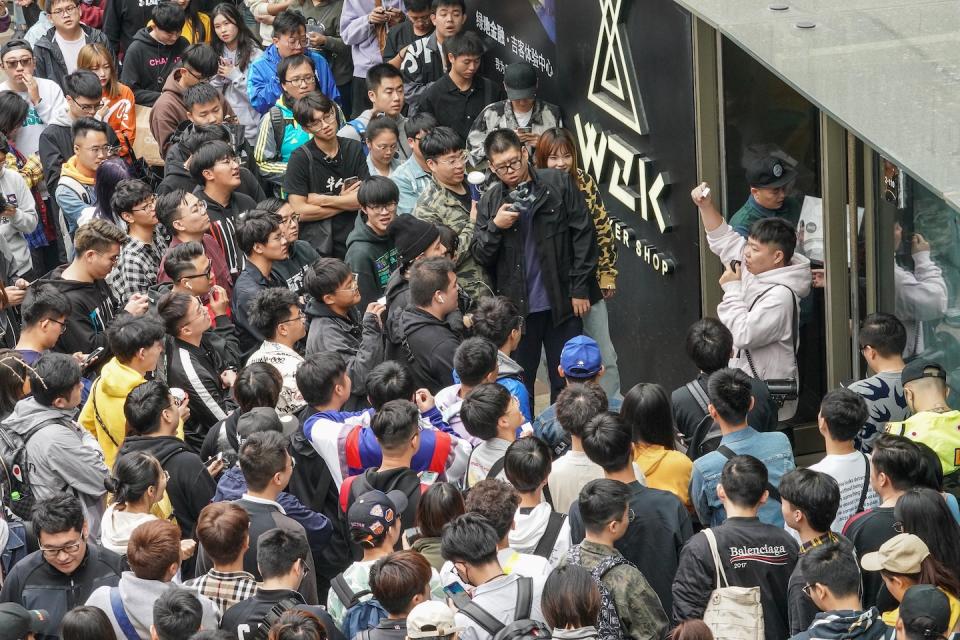 People outside a Nike store as they draw lots to buy a newly-released Nike sneaker in Shanghai (Photo: Getty Images)