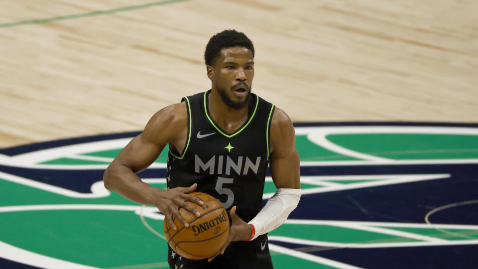 Malik Beasley with the ball in his hands during a game.