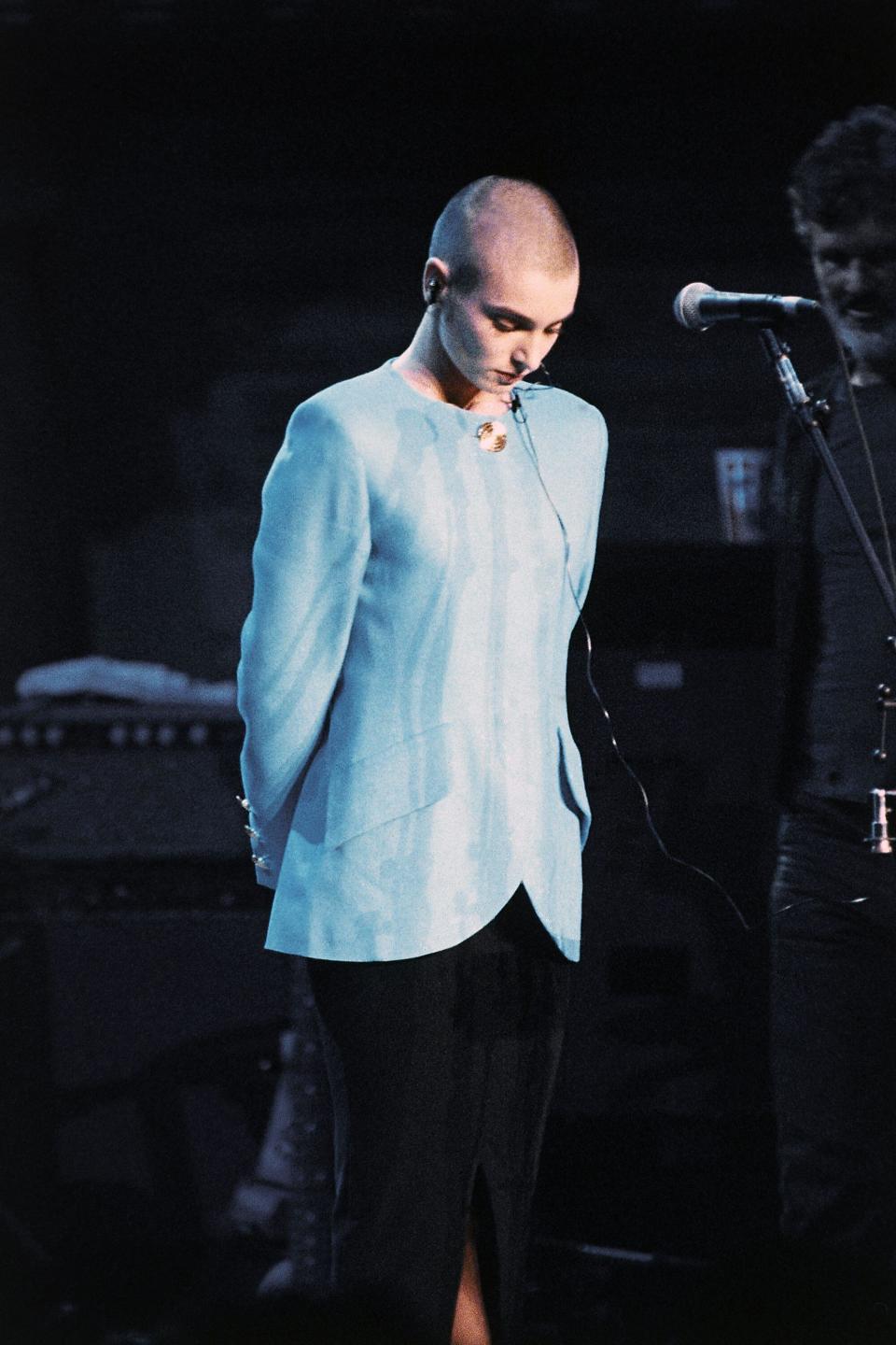 Irish singer Sinead O’Connor stands alone amidst boos on Oct. 16, 1992 in New York City, United States, reacting to her being on stage in response to her tearing up of a photo to Pope John Paul II on U.S. television. O’Connor was on stage at Bob Dylan’s 30th anniversary celebration of his first Columbia Records album’s release. O’Connor emotionally left the stage without performing. (AP Photo/Ron Frehm)