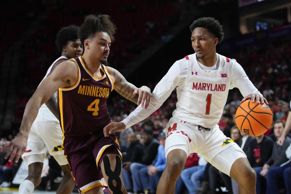 Maryland guard Jahmir Young (1) drives to the basket against Minnesota guard Braeden Carrington (4) during the second half of an NCAA college basketball game, Wednesday, Feb. 22, 2023, in College Park, Md. Maryland won 88-70. (AP Photo/Julio Cortez)