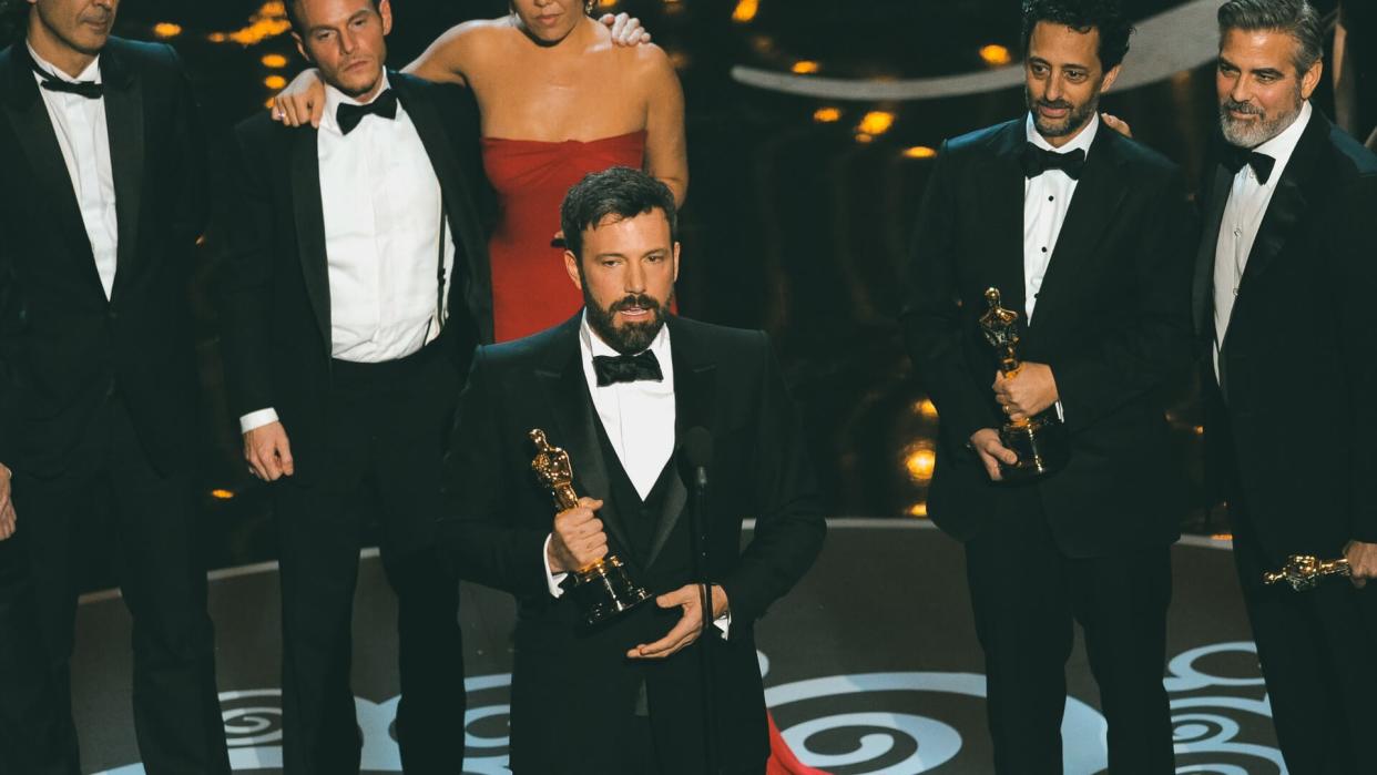 Director/producer Ben Affleck, center, accepts the award for best picture for "Argo," as the cast and crew look on during the Oscars at the Dolby Theatre, in Los Angeles85th Academy Awards - Show, Los Angeles, USA - 24 Feb 2013.